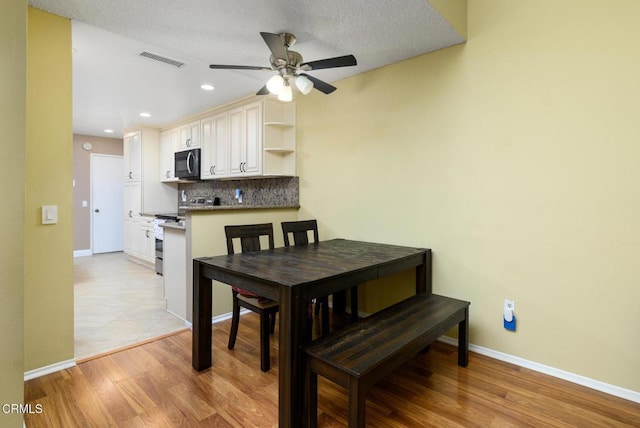 dining area with visible vents, baseboards, a ceiling fan, light wood-type flooring, and recessed lighting