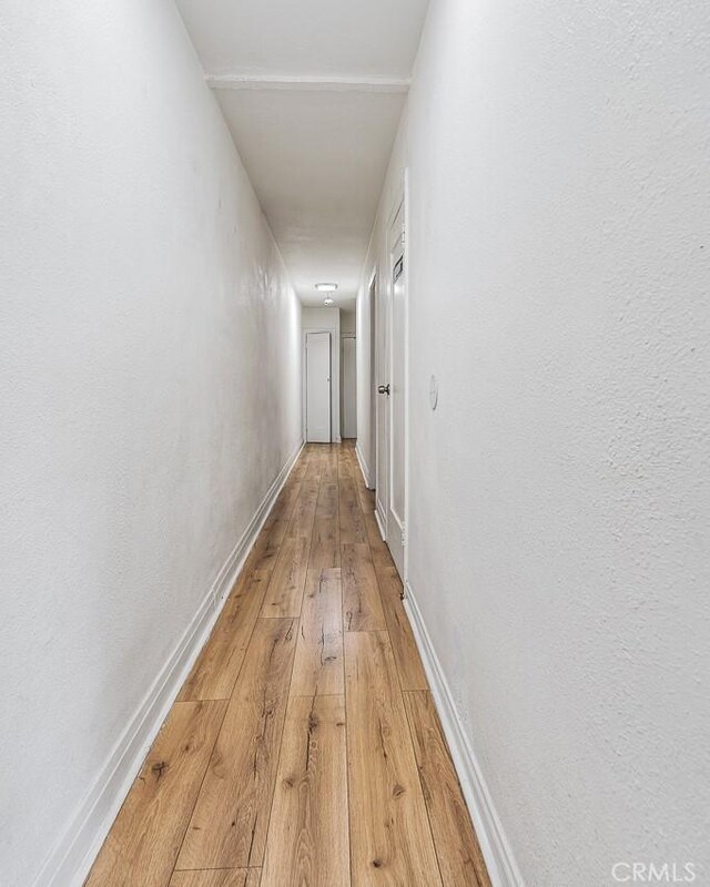 961 W 47th St, Los Angeles, CA 90037 - hallway with light wood-type flooring and baseboards
