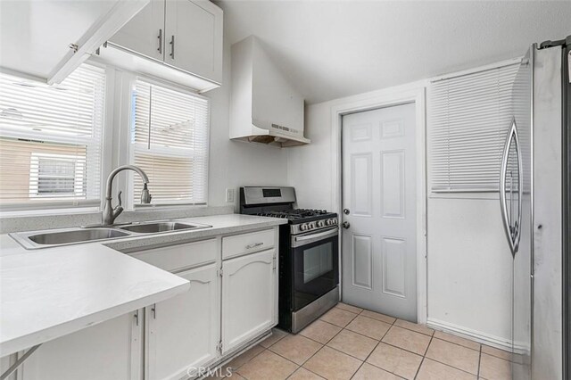 961 W 47th St, Los Angeles, CA 90037 - kitchen with stainless steel appliances, a sink, white cabinets, light tile patterned floors, and light countertops
