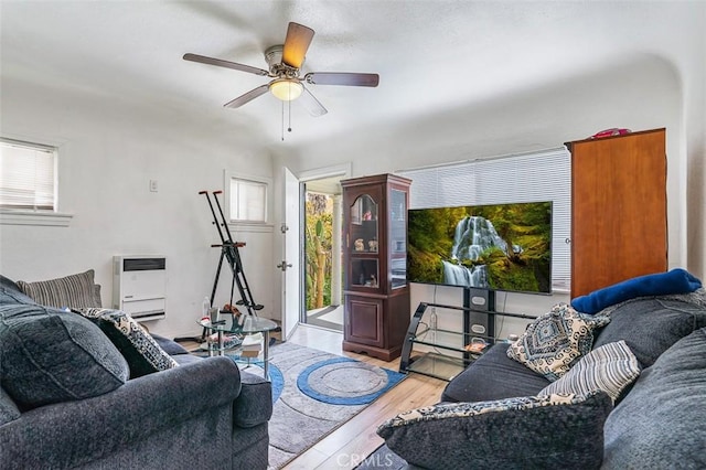 961 W 47th St, Los Angeles, CA 90037 - living area featuring plenty of natural light, wood finished floors, heating unit, and ceiling fan