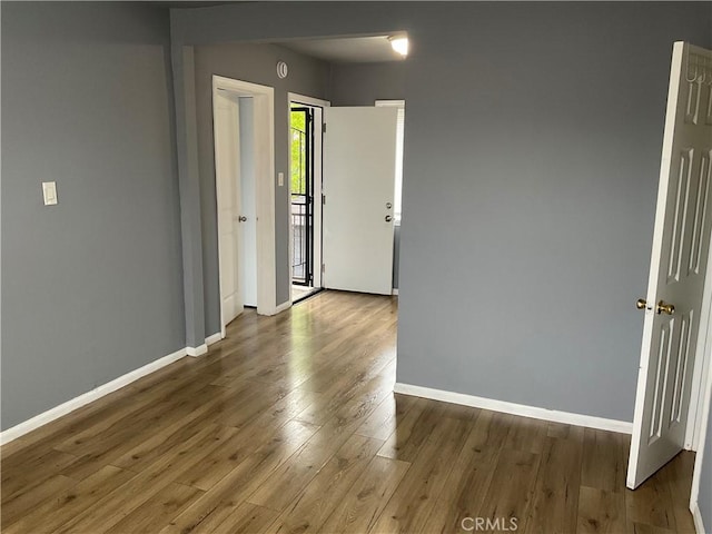 961 W 47th St, Los Angeles, CA 90037 - empty room featuring baseboards and wood finished floors