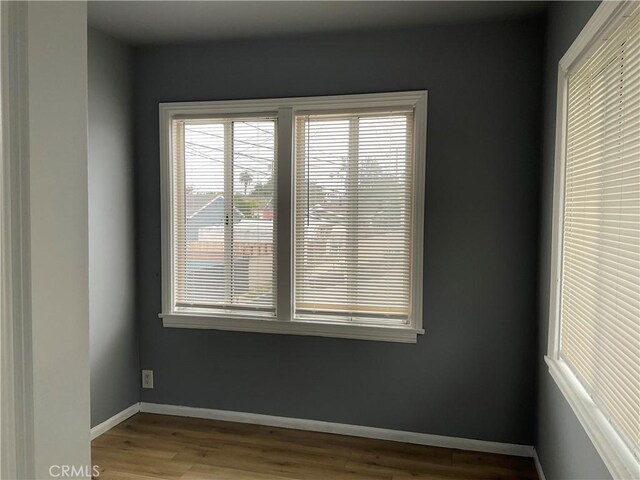961 W 47th St, Los Angeles, CA 90037 - unfurnished room featuring healthy amount of natural light, wood finished floors, and baseboards