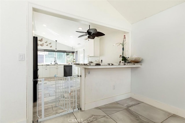 kitchen with dishwasher, white cabinetry, a ceiling fan, a peninsula, and lofted ceiling
