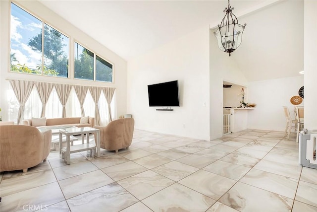 living area with high vaulted ceiling and marble finish floor