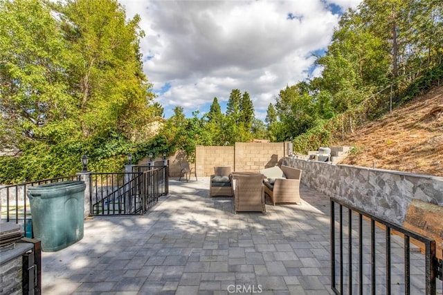 view of patio / terrace featuring fence and an outdoor hangout area