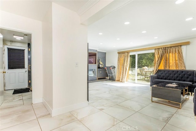 interior space featuring baseboards, recessed lighting, ornamental molding, and marble finish floor