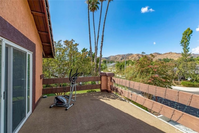 view of patio with a mountain view and a balcony