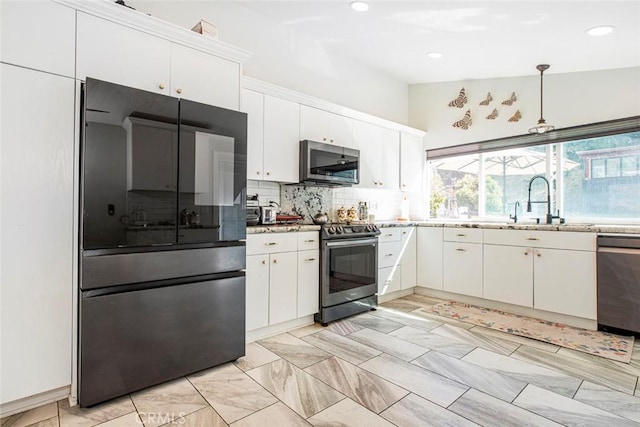 kitchen featuring recessed lighting, white cabinetry, stainless steel appliances, and decorative backsplash