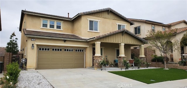 view of front of property featuring stucco siding, an attached garage, a tile roof, and concrete driveway