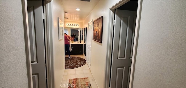 hall featuring a textured wall