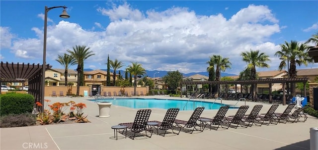 community pool featuring a pergola, fence, and a patio