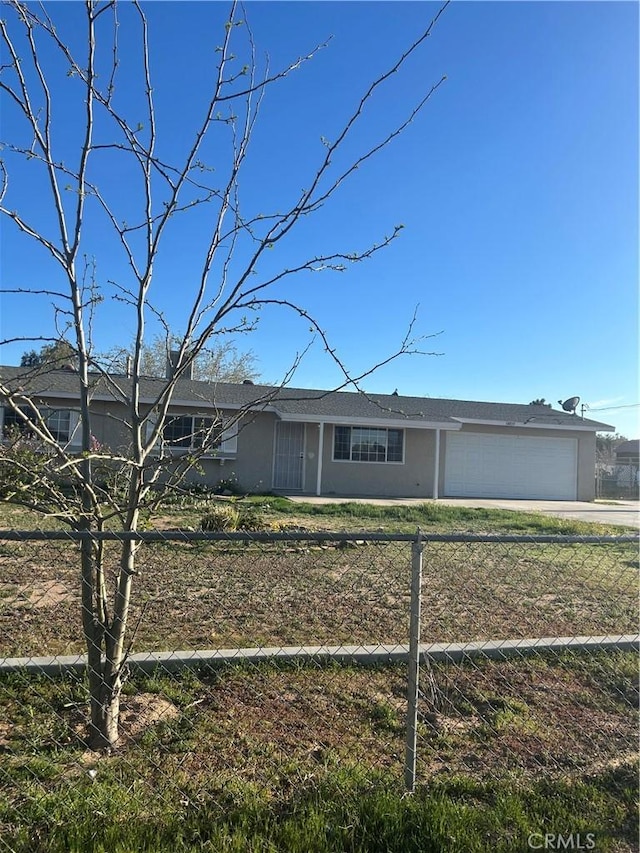 single story home featuring stucco siding, fence, concrete driveway, and a garage
