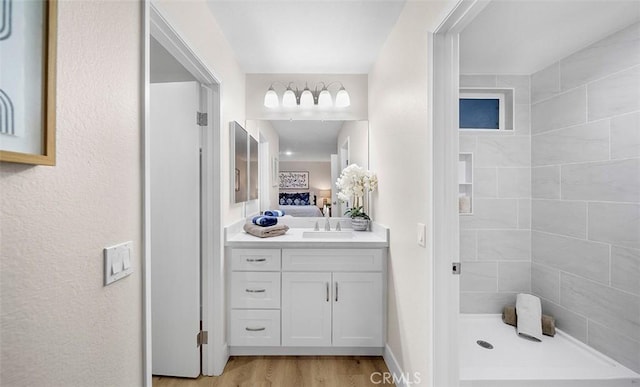10620 Gemini Dr, Riverside, CA 92503 - ensuite bathroom featuring wood finished floors, a stall shower, ensuite bathroom, and vanity