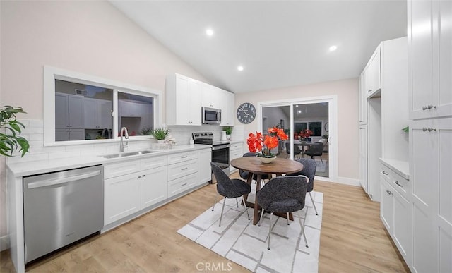 10620 Gemini Dr, Riverside, CA 92503 - kitchen featuring appliances with stainless steel finishes, a sink, light countertops, white cabinetry, and tasteful backsplash