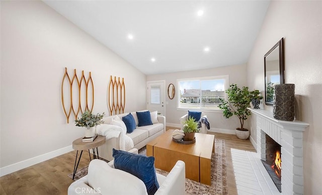 10620 Gemini Dr, Riverside, CA 92503 - living room featuring recessed lighting, wood finished floors, vaulted ceiling, and a fireplace