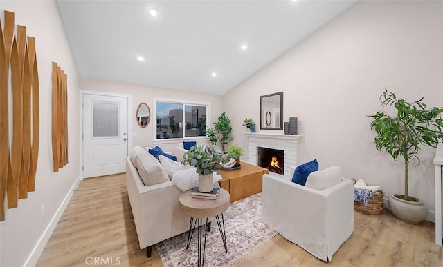 10620 Gemini Dr, Riverside, CA 92503 - living room featuring a fireplace, vaulted ceiling, light wood-type flooring, baseboards, and recessed lighting