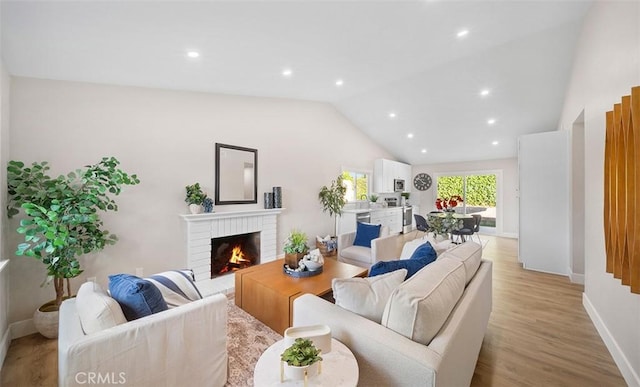 10620 Gemini Dr, Riverside, CA 92503 - living area with a fireplace, light wood-style flooring, recessed lighting, baseboards, and vaulted ceiling