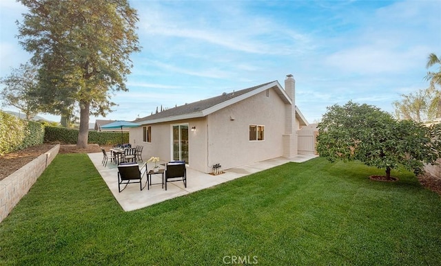 10620 Gemini Dr, Riverside, CA 92503 - rear view of property with a fenced backyard, stucco siding, a chimney, a patio area, and a yard