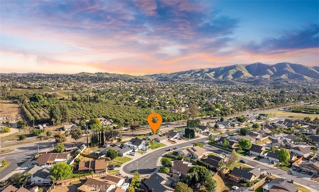 10620 Gemini Dr, Riverside, CA 92503 - aerial view at dusk featuring a residential view and a mountain view