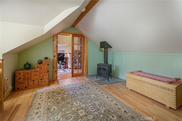 29 Bear Dr, Mt Baldy, CA 91759 - bedroom with lofted ceiling, wood finished floors, and a wood stove