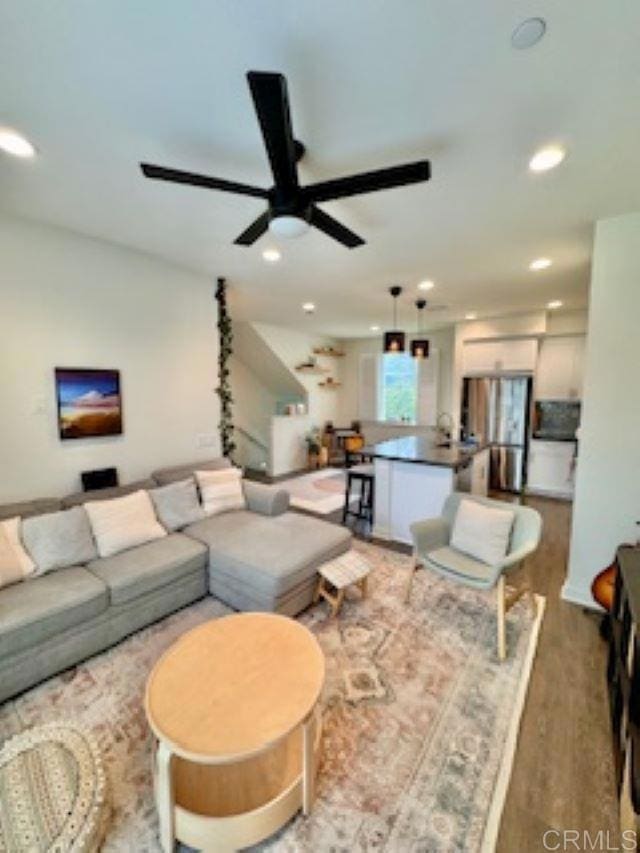 living room with a ceiling fan, wood finished floors, and recessed lighting