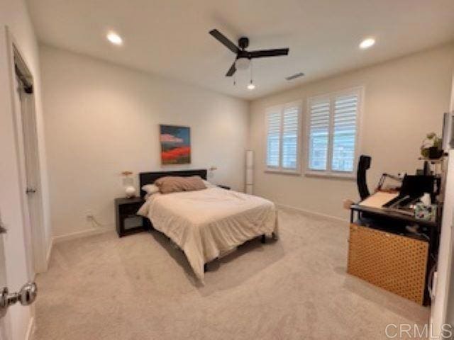bedroom featuring baseboards, light carpet, a ceiling fan, and recessed lighting