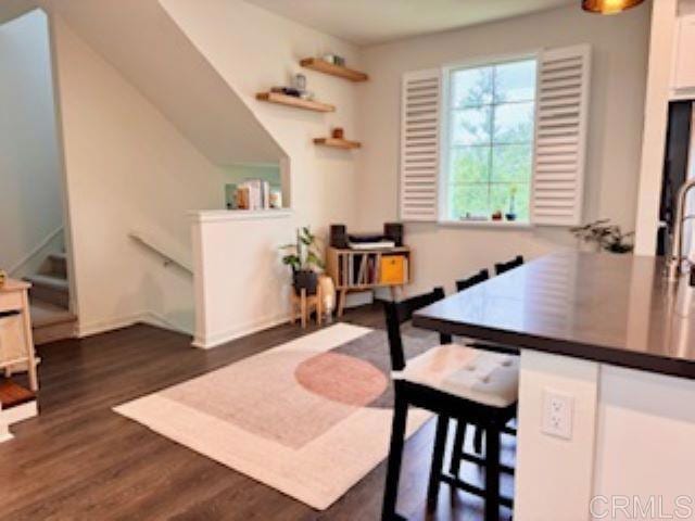 office with baseboards and dark wood-style flooring