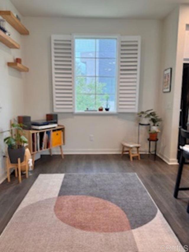 interior space with wood finished floors and baseboards