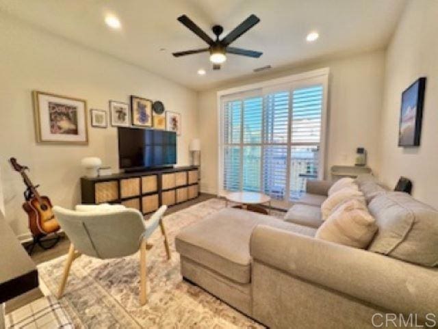 living room featuring a ceiling fan, baseboards, and recessed lighting