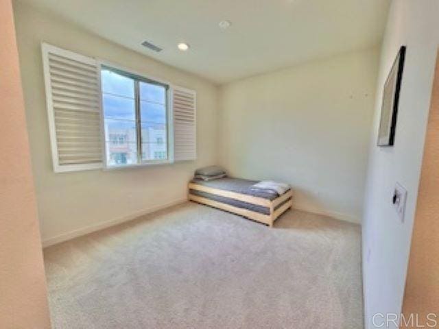 unfurnished bedroom featuring visible vents, baseboards, carpet flooring, and recessed lighting