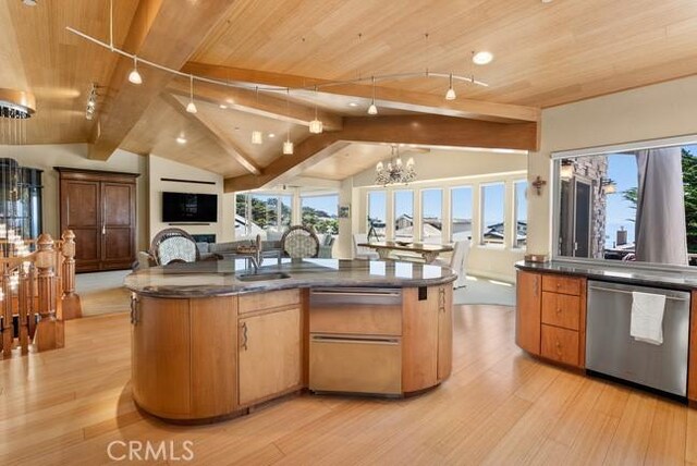 2062 Sherwood Dr, Cambria, CA 93428 - kitchen featuring dishwasher, dark countertops, wood ceiling, open floor plan, and light wood-style floors