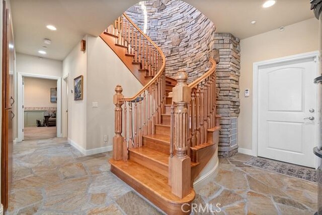 2062 Sherwood Dr, Cambria, CA 93428 - foyer featuring stone flooring, recessed lighting, stairway, and baseboards