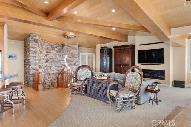 2062 Sherwood Dr, Cambria, CA 93428 - living area with a glass covered fireplace, recessed lighting, wooden ceiling with exposed beams, and wood finished floors