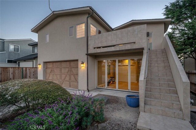 2062 Sherwood Dr, Cambria, CA 93428 - back of house with a balcony, stucco siding, and an attached garage