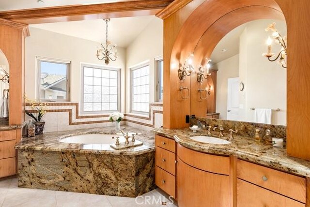 2062 Sherwood Dr, Cambria, CA 93428 - bathroom with a chandelier, vanity, tile patterned flooring, and a garden tub