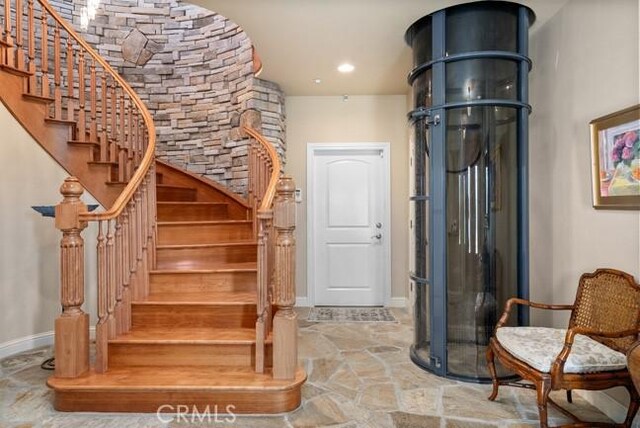 2062 Sherwood Dr, Cambria, CA 93428 - stairway featuring baseboards and stone finish flooring