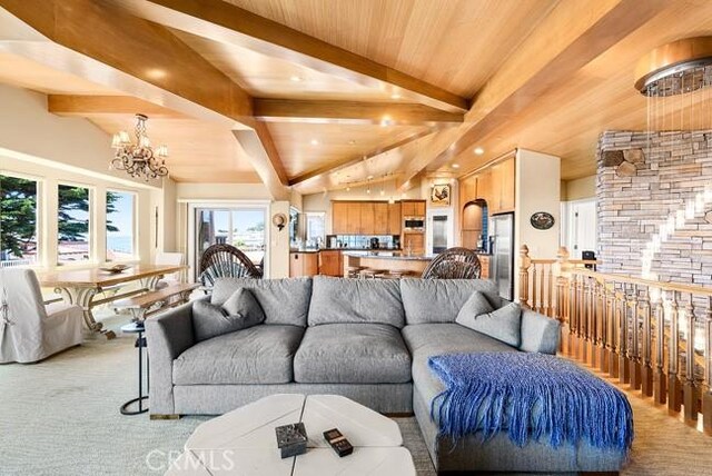 2062 Sherwood Dr, Cambria, CA 93428 - living area with a chandelier, light colored carpet, and wooden ceiling