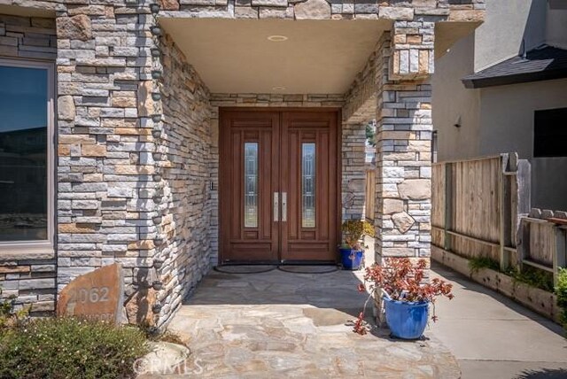 2062 Sherwood Dr, Cambria, CA 93428 - property entrance featuring stone siding and french doors