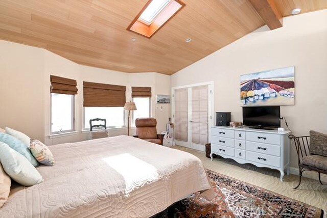 2062 Sherwood Dr, Cambria, CA 93428 - carpeted bedroom featuring a skylight, wood ceiling, and baseboards