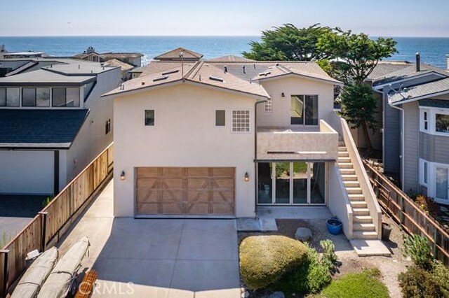 2062 Sherwood Dr, Cambria, CA 93428 - view of front of property with stucco siding, stairway, a garage, a water view, and concrete driveway