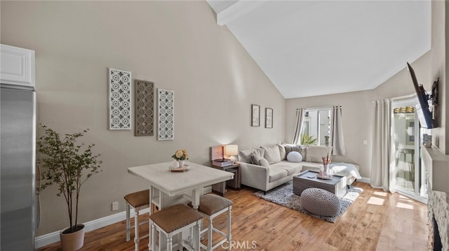 10 Via Garceta, Rancho Santa Margarita, CA 92688 - living area with baseboards, high vaulted ceiling, and light wood finished floors