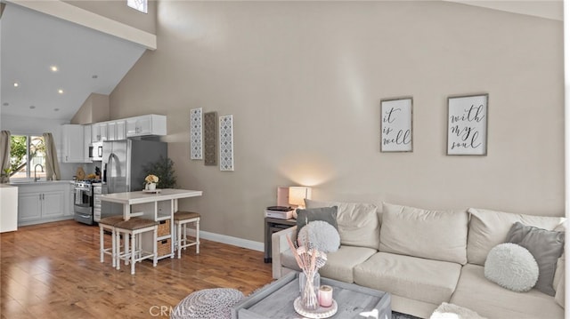 10 Via Garceta, Rancho Santa Margarita, CA 92688 - living area featuring baseboards, high vaulted ceiling, recessed lighting, and light wood finished floors