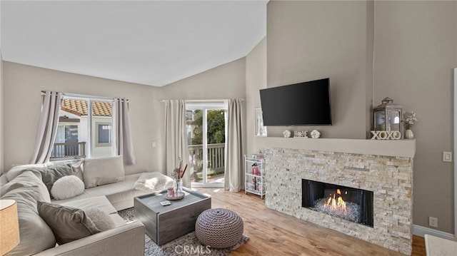 10 Via Garceta, Rancho Santa Margarita, CA 92688 - living area featuring a stone fireplace, high vaulted ceiling, and wood finished floors