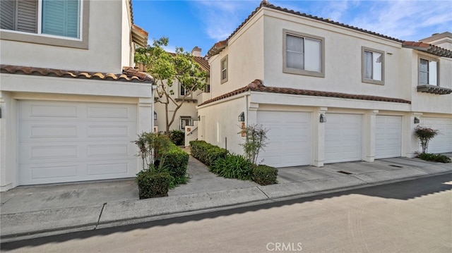 10 Via Garceta, Rancho Santa Margarita, CA 92688 - view of side of property with an attached garage, a tiled roof, and stucco siding