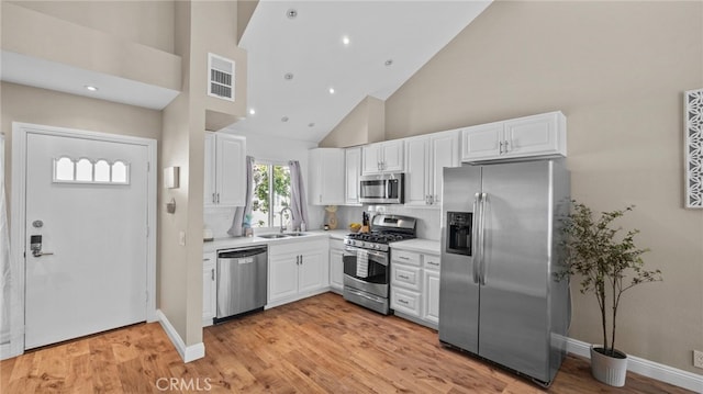 10 Via Garceta, Rancho Santa Margarita, CA 92688 - kitchen with a sink, high vaulted ceiling, white cabinetry, and stainless steel appliances