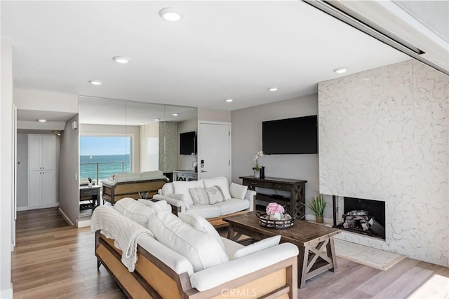 2208 The Strand, Manhattan Beach, CA 90266 - living area featuring a premium fireplace, light wood-style floors, and recessed lighting