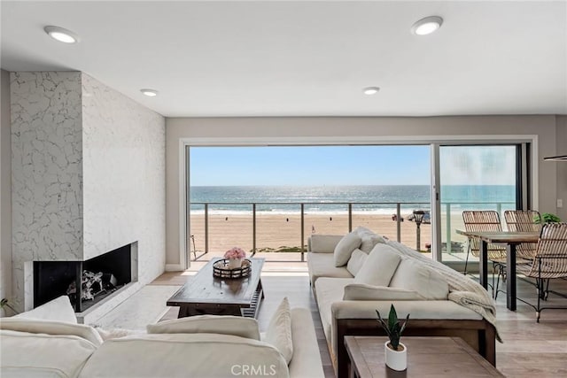 2208 The Strand, Manhattan Beach, CA 90266 - living area with light wood-type flooring, a beach view, a fireplace, and a water view