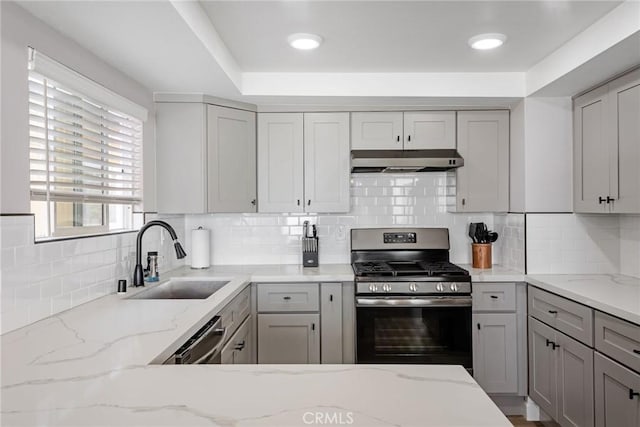 2208 The Strand, Manhattan Beach, CA 90266 - kitchen with a sink, decorative backsplash, gas range, under cabinet range hood, and gray cabinetry