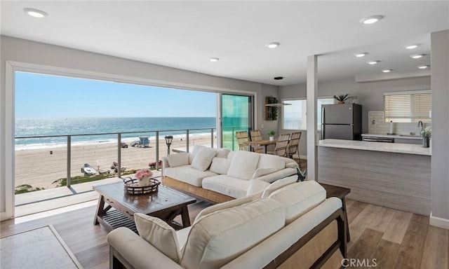 2208 The Strand, Manhattan Beach, CA 90266 - living area with light wood-style floors, a view of the beach, a water view, baseboards, and recessed lighting