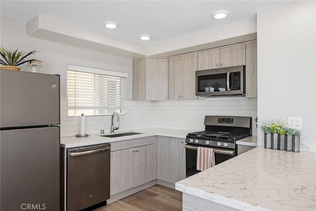 2208 The Strand, Manhattan Beach, CA 90266 - kitchen featuring light brown cabinets, light stone counters, tasteful backsplash, a sink, and stainless steel appliances